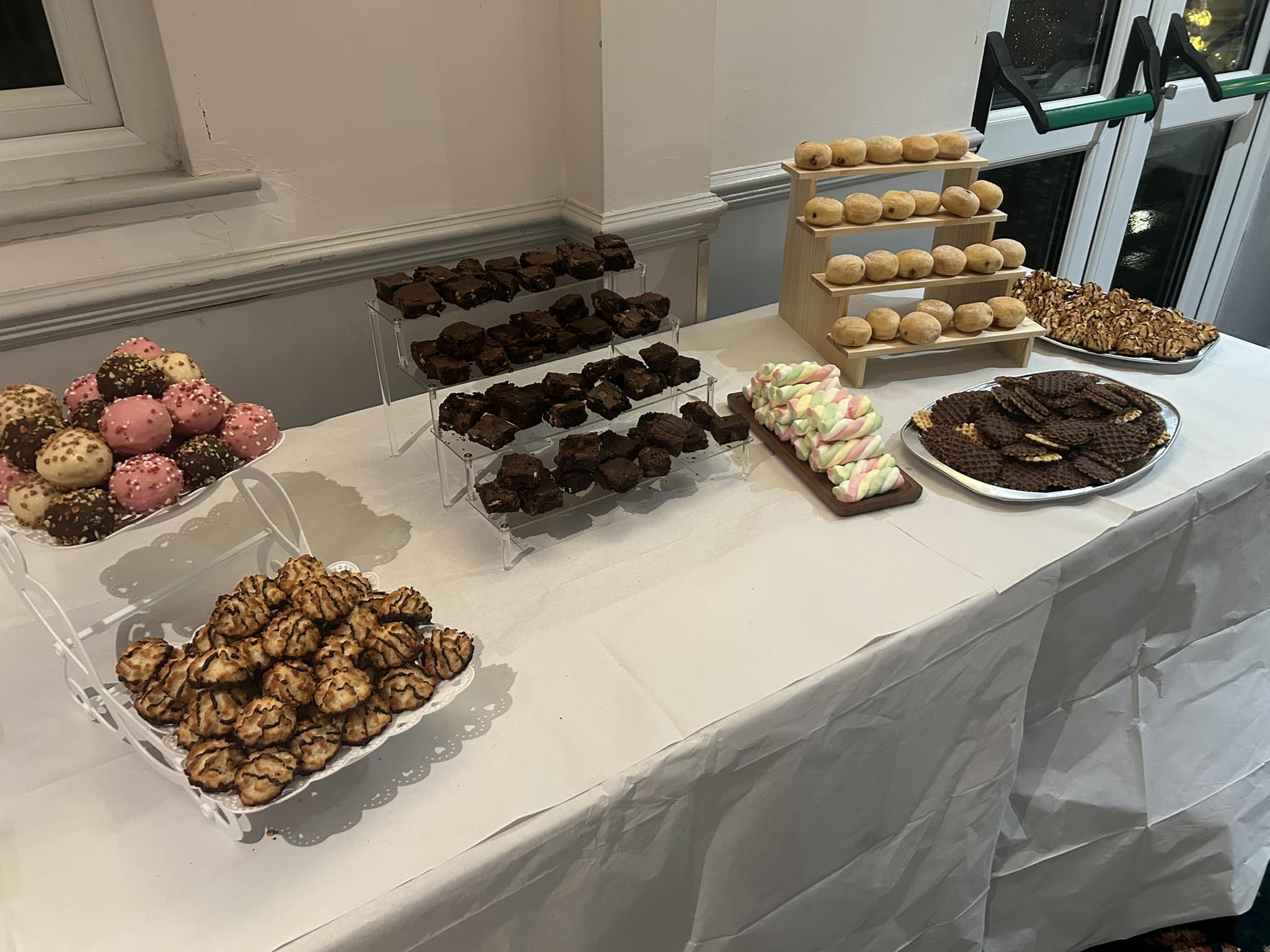 Dessert table with brownies, macarons and stacked doughnuts